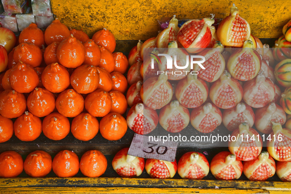 Fancy candles in the shape of fruit are being displayed at a small shop in Nainital, Uttarakhand, India, on April 21, 2024. 