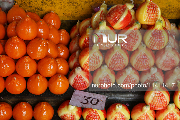 Fancy candles in the shape of fruit are being displayed at a small shop in Nainital, Uttarakhand, India, on April 21, 2024. 