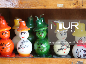 Fancy candles in the shape of snowmen are being displayed at a small shop in Nainital, Uttarakhand, India, on April 21, 2024. (