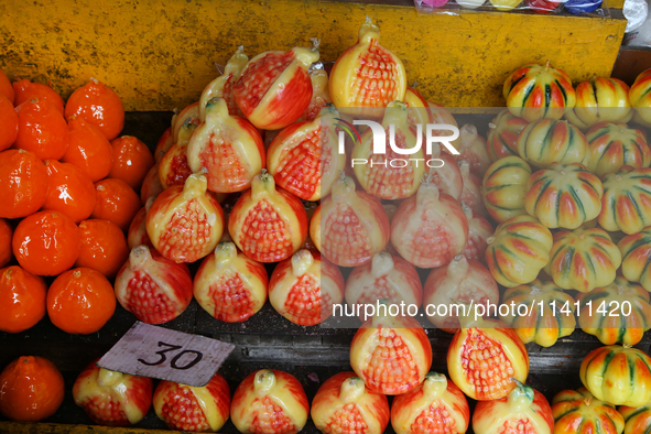 Fancy candles in the shape of fruit are being displayed at a small shop in Nainital, Uttarakhand, India, on April 21, 2024. 