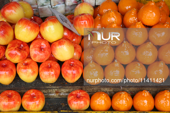 Fancy candles in the shape of fruit are being displayed at a small shop in Nainital, Uttarakhand, India, on April 21, 2024. 