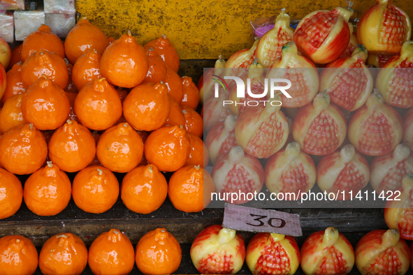 Fancy candles in the shape of fruit are being displayed at a small shop in Nainital, Uttarakhand, India, on April 21, 2024. 