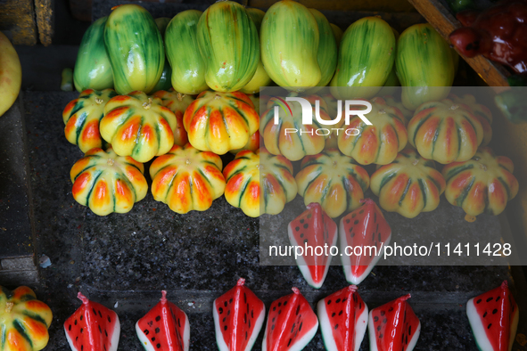 Fancy candles in the shape of fruit are being displayed at a small shop in Nainital, Uttarakhand, India, on April 21, 2024. 