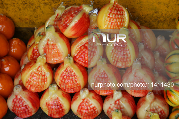 Fancy candles in the shape of fruit are being displayed at a small shop in Nainital, Uttarakhand, India, on April 21, 2024. 