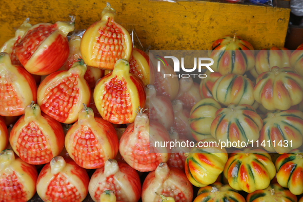 Fancy candles in the shape of fruit are being displayed at a small shop in Nainital, Uttarakhand, India, on April 21, 2024. 