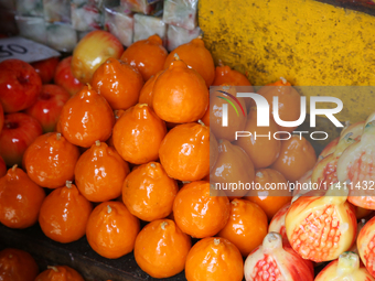 Fancy candles in the shape of fruit are being displayed at a small shop in Nainital, Uttarakhand, India, on April 21, 2024. (