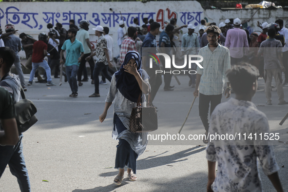 An unidentified student is fleeing during a clash between BCL members and Quota Student Protesters in Dhaka, Bangladesh, on July 15, 2024. 