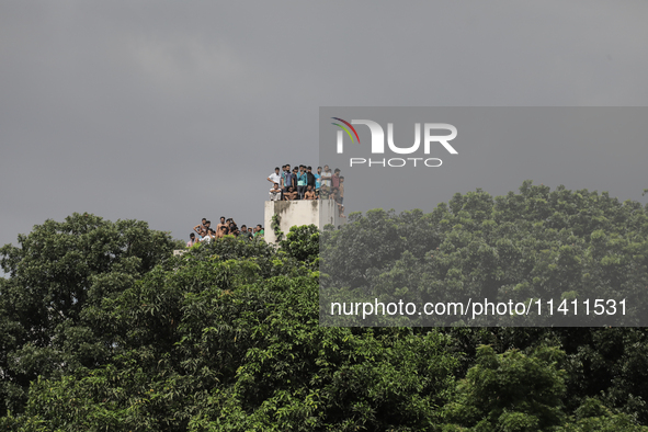 Students of Dhaka University are observing the clash between BCL members and Quota Student Protesters from the rooftop of a dormitory in Dha...