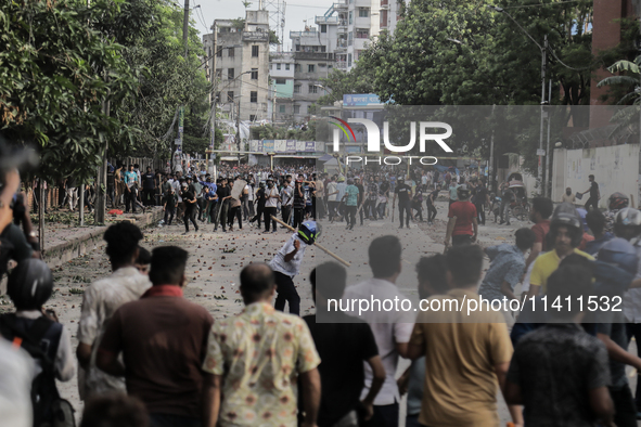 A BCL member and a Quota Student protester are clashing in Dhaka, Bangladesh, on July 15, 2024. 