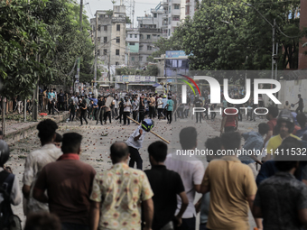 A BCL member and a Quota Student protester are clashing in Dhaka, Bangladesh, on July 15, 2024. (