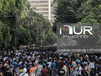 Smoke is rising after a crude bomb is exploding during a clash between BCL and student protestors in Dhaka, Bangladesh, on July 15, 2024. (