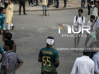 An unidentified student is being seen with a head bandage as he is injured during a clash between BCL members and Quota Student Protesters i...