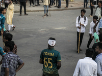 An unidentified student is being seen with a head bandage as he is injured during a clash between BCL members and Quota Student Protesters i...