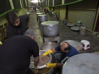 Iranian men are preparing donated meals during a religious festival to commemorate Tasoua, a day ahead of Ashura, in the Grand Bazaar, in so...