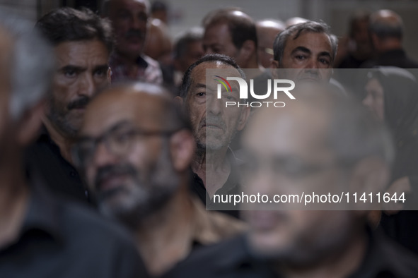 An elderly Iranian man is looking on while waiting to receive a donated meal, during a religious festival to commemorate Tasoua, a day ahead...