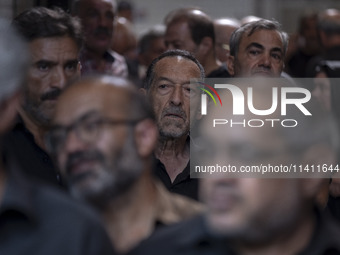 An elderly Iranian man is looking on while waiting to receive a donated meal, during a religious festival to commemorate Tasoua, a day ahead...