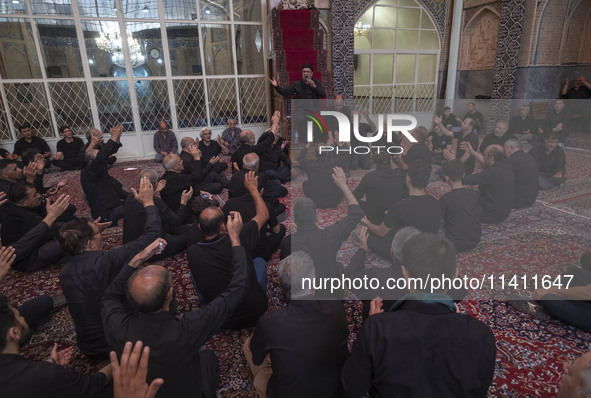 Iranian mourners are beating themselves while participating in a religious festival to commemorate Tasoua, a day ahead of Ashura, at a mosqu...