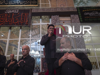 Iranian mourners are beating themselves while participating in a religious festival to commemorate Tasoua, a day ahead of Ashura, at a mosqu...