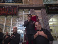 Iranian mourners are beating themselves while participating in a religious festival to commemorate Tasoua, a day ahead of Ashura, at a mosqu...