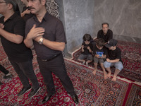 Iranian mourners are beating themselves while participating in a religious festival to commemorate Tasoua, a day ahead of Ashura, at a mosqu...