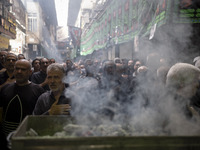 Iranian mourners are beating themselves while participating in a religious festival to commemorate Tasoua, a day ahead of Ashura, in the Gra...