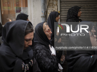 An Iranian woman is beating herself while participating in a religious festival to commemorate Tasoua, a day ahead of Ashura, in the Grand B...