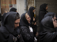 An Iranian woman is beating herself while participating in a religious festival to commemorate Tasoua, a day ahead of Ashura, in the Grand B...