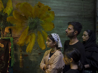 An Iranian family is participating in a religious festival to commemorate Tasoua, a day ahead of Ashura, in the Grand Bazaar, in southern Te...