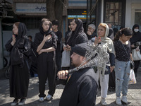 An Iranian mourner is beating himself with a chain during a religious festival to commemorate Tasoua, a day ahead of Ashura, in the Grand Ba...