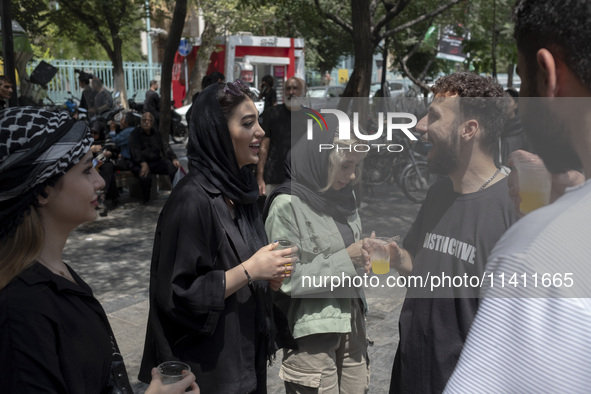 Iranian youths are standing together outside the Grand Bazaar (Market), during a religious festival to commemorate Tasoua, a day ahead of As...