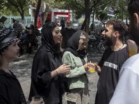 Iranian youths are standing together outside the Grand Bazaar (Market), during a religious festival to commemorate Tasoua, a day ahead of As...