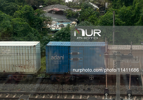 A goods train is carrying Adani Group containers and is moving towards a railyard in Kolkata, India, on July 15, 2024. 