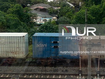 A goods train is carrying Adani Group containers and is moving towards a railyard in Kolkata, India, on July 15, 2024. (