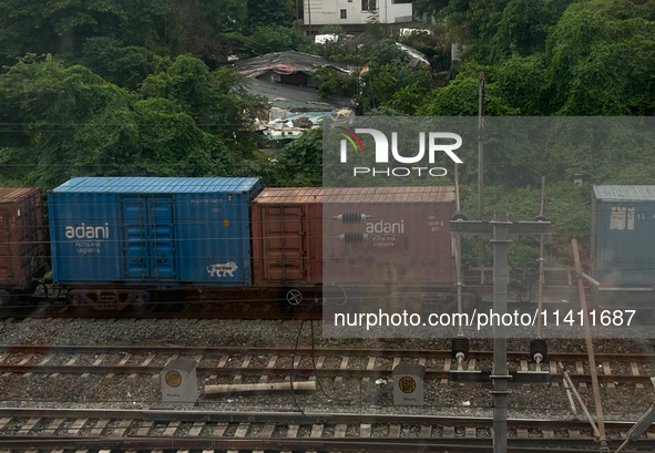 A goods train is carrying Adani Group containers and is moving towards a railyard in Kolkata, India, on July 15, 2024. 