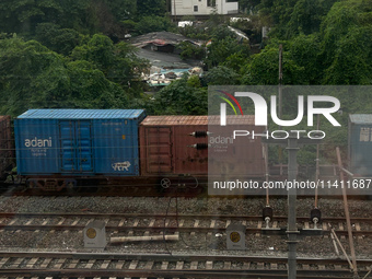 A goods train is carrying Adani Group containers and is moving towards a railyard in Kolkata, India, on July 15, 2024. (