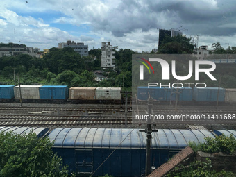 A goods train is carrying Adani Group containers and is moving towards a railyard in Kolkata, India, on July 15, 2024. (