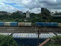 A goods train is carrying Adani Group containers and is moving towards a railyard in Kolkata, India, on July 15, 2024. (