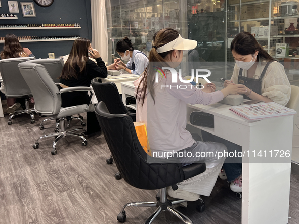 A manicurist is polishing and shaping the fingernails of a customer in Markham, Ontario, Canada, on June 08, 2024. 