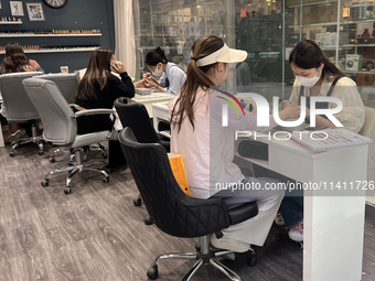 A manicurist is polishing and shaping the fingernails of a customer in Markham, Ontario, Canada, on June 08, 2024. (