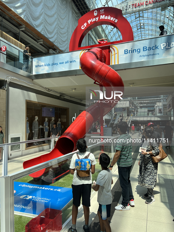 A person is sliding in the Toronto Eaton Centre in Toronto, Ontario, Canada, on July, 13, 2024. 