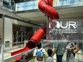 A person is sliding in the Toronto Eaton Centre in Toronto, Ontario, Canada, on July, 13, 2024. (