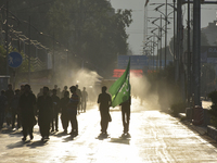 Kashmiri Shia Muslims are carrying a flag during a procession on the 8th of Muharram in Srinagar, Indian Administered Kashmir, on July 15, 2...