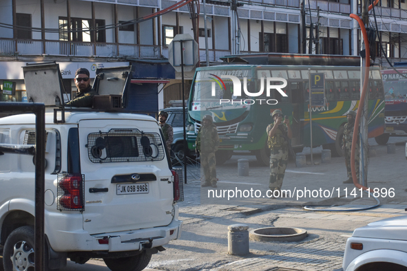 Indian troopers are clicking pictures during a procession on the 8th of Muharram in Srinagar, Indian Administered Kashmir, on July 15, 2024....