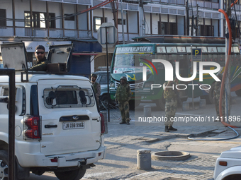 Indian troopers are clicking pictures during a procession on the 8th of Muharram in Srinagar, Indian Administered Kashmir, on July 15, 2024....