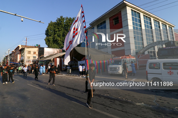 Kashmiri Shia Muslims are carrying a flag during a procession on the 8th of Muharram in Srinagar, Indian Administered Kashmir, on July 15, 2...