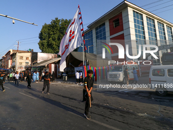 Kashmiri Shia Muslims are carrying a flag during a procession on the 8th of Muharram in Srinagar, Indian Administered Kashmir, on July 15, 2...