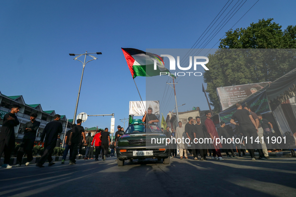 Kashmiri Shia Muslims are waving the Palestinian flag during a procession on the 8th of Muharram in Srinagar, Indian Administered Kashmir, o...