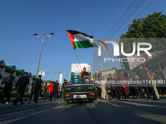 Kashmiri Shia Muslims are waving the Palestinian flag during a procession on the 8th of Muharram in Srinagar, Indian Administered Kashmir, o...