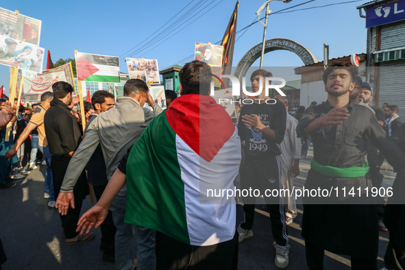 A Kashmiri Shia Muslim man is displaying a Palestinian flag during a procession on the 8th of Muharram in Srinagar, Indian Administered Kash...