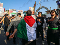 A Kashmiri Shia Muslim man is displaying a Palestinian flag during a procession on the 8th of Muharram in Srinagar, Indian Administered Kash...